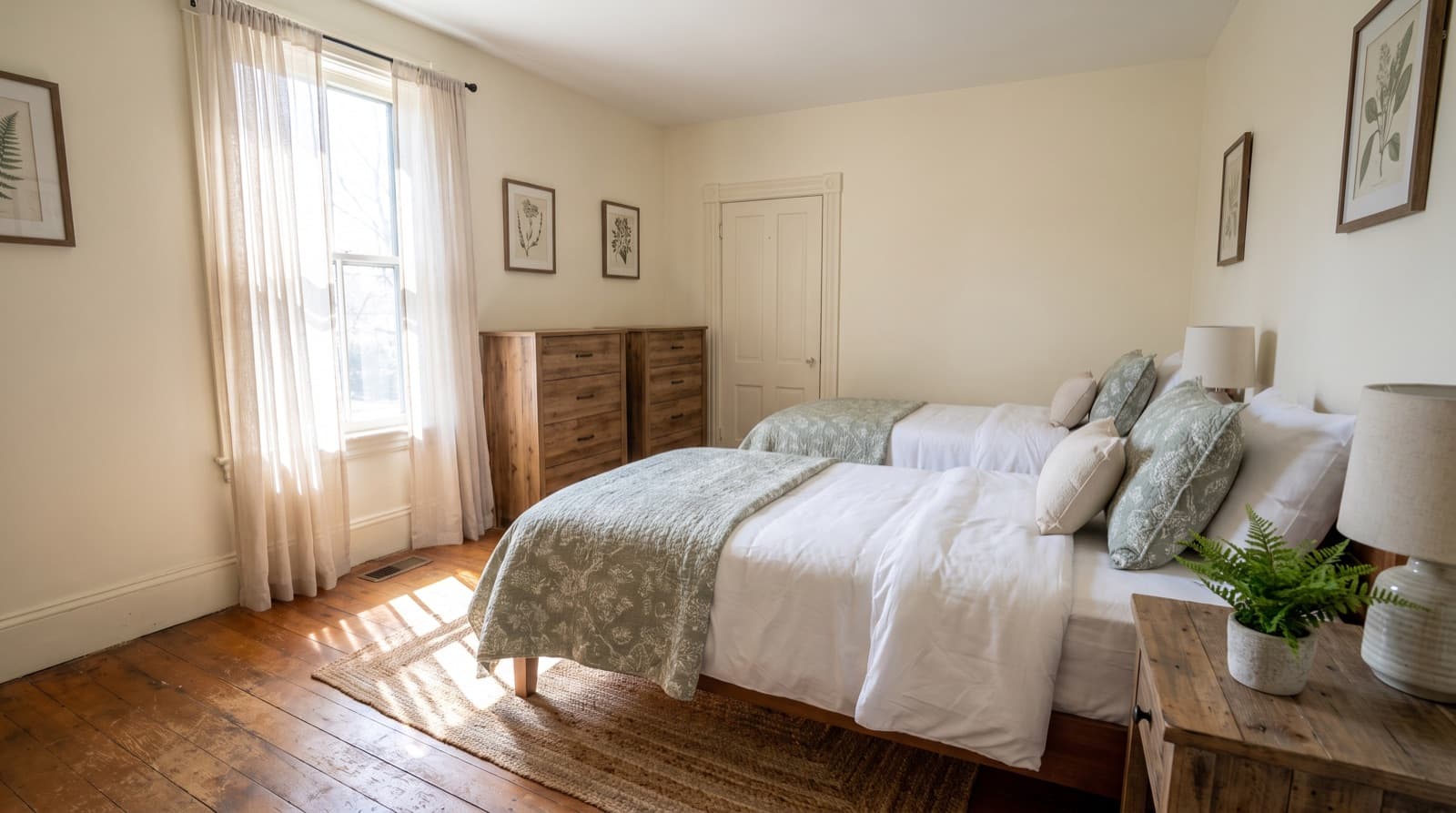 Bright shared bedroom with two twin beds in a sober living home